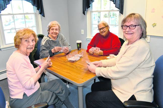 Joan Wills, Linda Fiedler, Gloria Diabo and Pat Kibildis, all of Sparta, play a card game.