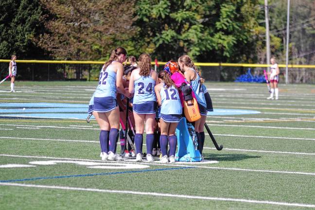 The Spartans meet in a huddle before the start of the game.