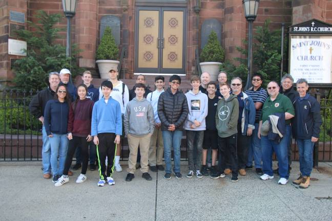 Squires, Roses, and parents stand in front of the historic Saint John’s Church and Food Pantry following their morning service project. (Photos submitted)