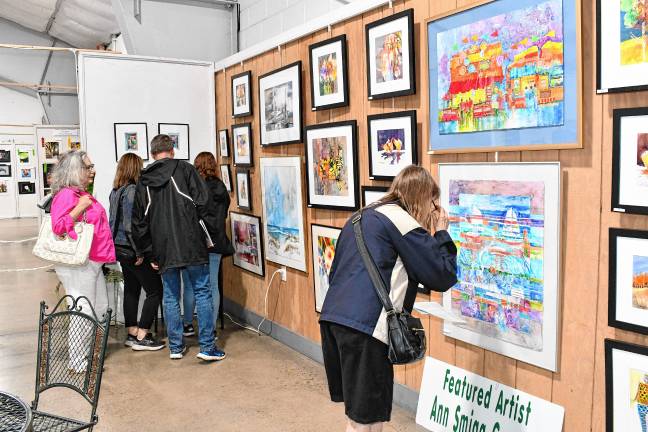 <b>Residents look at the Art in Sussex County show during a Meet the Artists reception Thursday evening, July 31 in the Richards Building at the Sussex County Fairgrounds in Augusta. (Photos by Maria Kovic)</b>