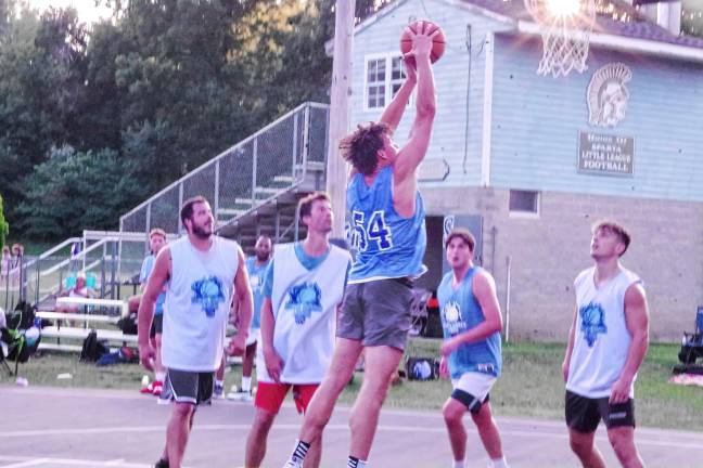 SB5 Team Mastandrea's Mike Piwko (54) reaches for the basket in a game against Team Smalley.