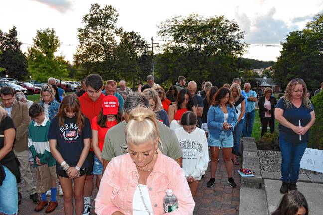 Residents bow their heads during a vigil Sunday, Sept. 14 in Sparta for Charlie Kirk, who was shot and killed Wednesday, Sept. 10 while speaking on a college campus in Utah. (Photos by Maria Kovic)