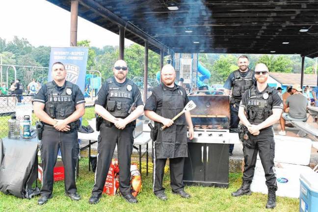 Police officers man the grill during the National Night Out event Tuesday, Aug. 5 in Franklin.