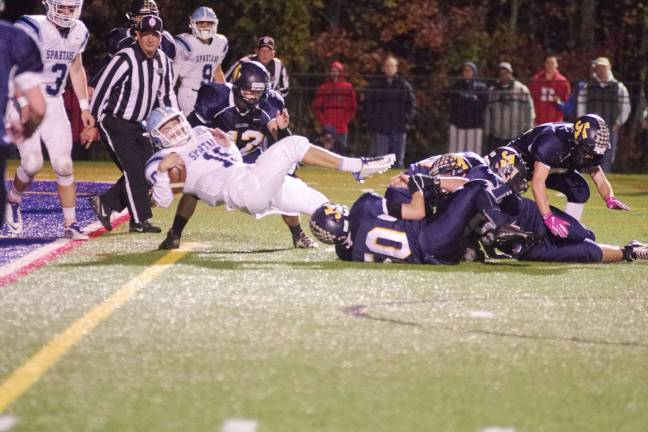 Sparta quarterback Anthony Broccoletti stumbles backwards to the one yard line in the third quarter.