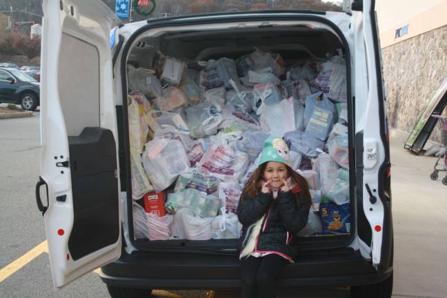 Peighton Spidaletto, daughter of Sparta's police chief, has a little fun while helping out at Cram the Cruiser/Stuff the Bus 2017 at Stop &amp; Shop on Sunday, Nov.19.