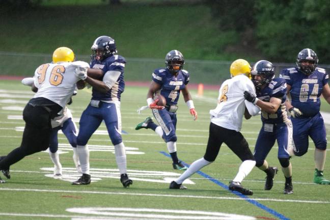Stags running back Jeff Mack moves the ball forward as his teammates hold back the Knights in the second quarter.