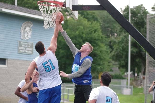 Team Tobin's Almin Hodzic (51) blocks the shot of Team Synol's Mike DeLorenzo.