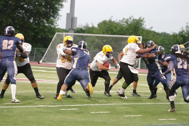 A Knights ball carrier runs towards an opening in the Stags defensive line in the second quarter.