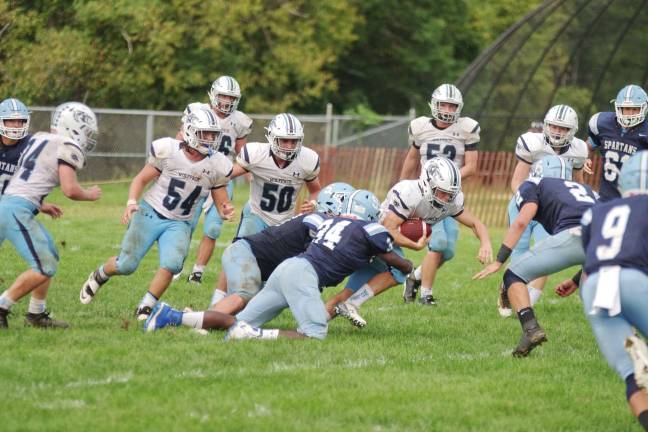Sparta defenders take down a West Morris Central ball carrier in the second half.