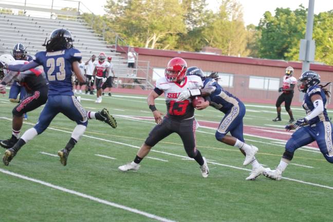 A Silk City ball carrier is caught by a Sussex defender in the first quarter.