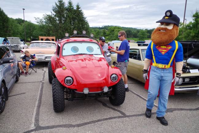 Herbie the Sussex County Miner tours the rows of classic vehicles on display.