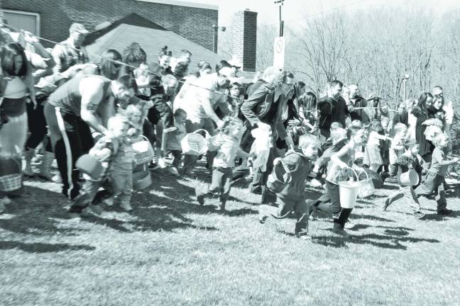 An they're off! Children rush out into the field to search for colored eggs.