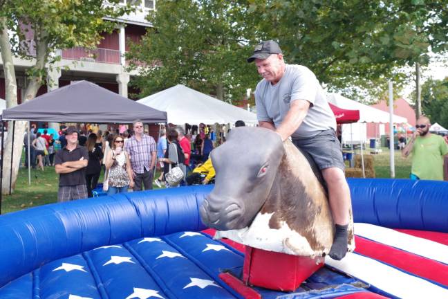 Steve Gumann of Freehold during one of his attempts to ride the hornless bull with a very slippery saddle, at last year's event.