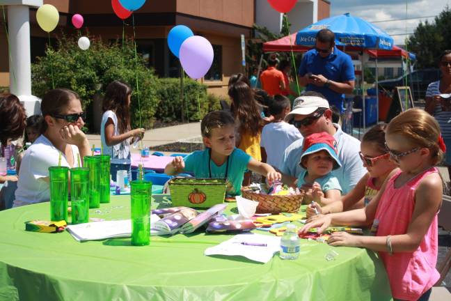 Sisters Brooke and Caitlyn Geoghegan enjoy making door hangers with the Wagner family.