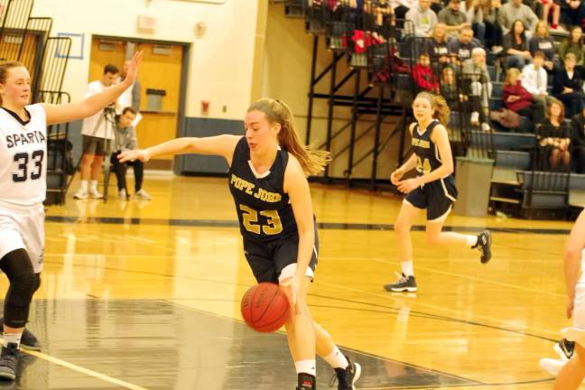 Pope John's Morgan Heller dribbles the ball in the second period. Heller scored one point and grabbed six rebounds.