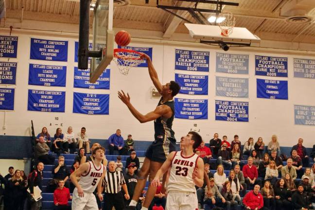 The ball bounces off of the rim as Pope John's Marcus Hopkins fails to dunk in the fourth period. Hopkins scored one point, grabbed 12 rebounds and blocked three shots.