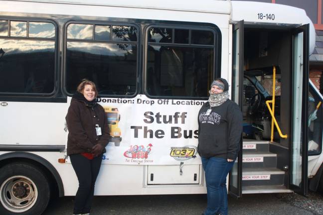 Ronda Konik and Allison Lisk from the Division of Social Services bundle up to collect food last Sunday for Stuff the Bus 2017 outside of the former Carl&#x2019;s Auto in Lake Mohawk. Photos by Rose Sgarlato