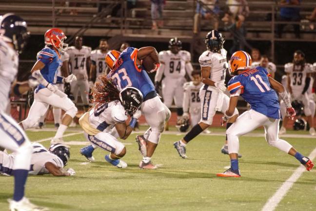 Gators ball carrier Daryl Shuler is caught from behind by Stags linebacker Joe Davis after a long gain in the second half. Photos by George Leroy Hunter
