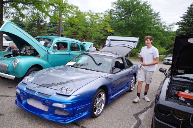Seventeen year old Andrew Van Hook of Newton, N.J. stands next to his customized 1991 Nissan 240 SX low rider.