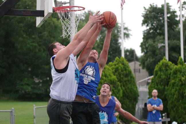 Team Tobin's Elvis Hodzic and Team Synol's Vinny Synol reach for the ball during a rebound. Photos by George Leroy Hunter