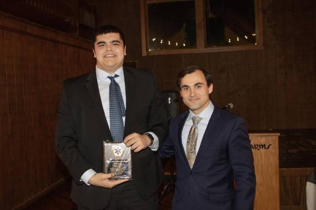 SQ3 Matthew Enriquez, left, was presented with the EMT of the Year award by Capt. Max Merlino.