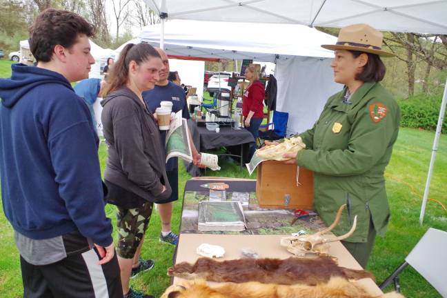 Park ranger Rainey McKenna shows a bear skull to visitors.
