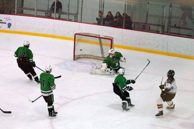 At far right Sparta-Jefferson's Matt Redding watches the puck he struck zip past Kinnelon's goalkeeper and hit the net resulting in a goal in the third period.