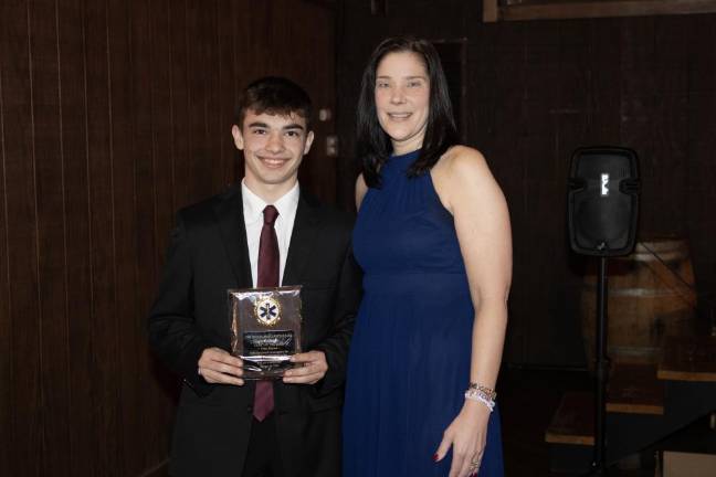 SQ4 Cadet coordinator Allyson Wright presents the Cadet of the Year award to Tyler Harms.