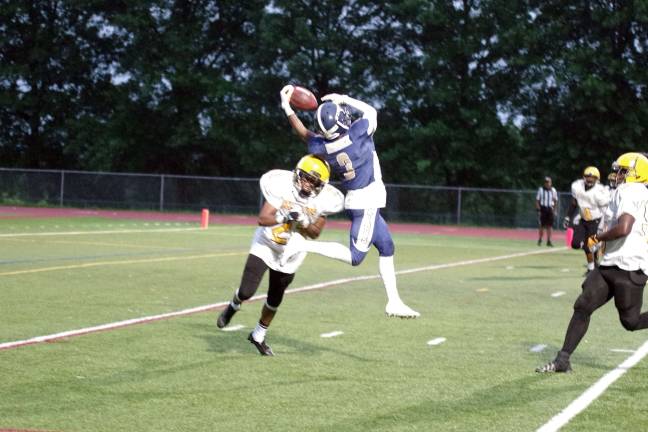 Stags wideout Yusef Reddick makes a leaping catch against tight coverage by Knights defender Jihad Myers in the second quarter.