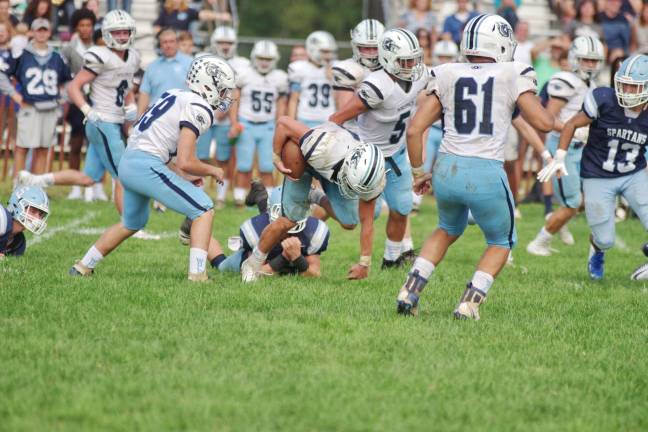 West Morris Central ball carrier Jack Dipietro is tripped up by a Sparta defender during a kick return.