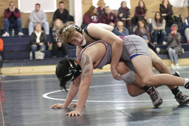 Pope John's Jack Stoll on top of Don Bosco's Torin Jacobs in the 160 pound match. Stoll pinned Jacobs to earn the win.