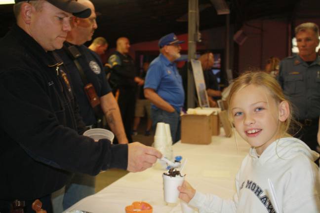 Sparta Fire Department's Chris Angelucci serves Leisl Hessel some pumpkin ice cream.