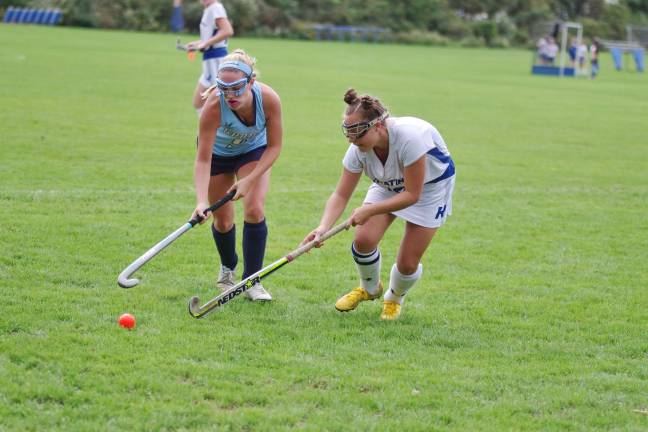 Sparta's Audrey Krajicek and Kittatinny's Jess Smalley use their sticks to reach for the ball.