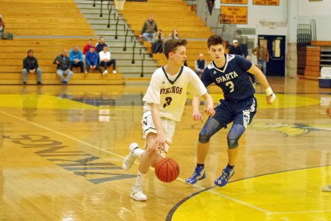 Vernon's Paul McVeigh dribbles the ball past Sparta's Jack Cavanaugh in the fourth period. McVeigh scored four points, grabbed six rebounds and made two assists.
