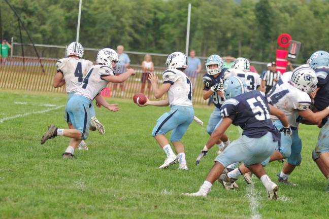 In the second half the West Morris Central Wolfpack perform a hand-off play as Sparta Spartans encroach. Photos by George Leroy Hunter