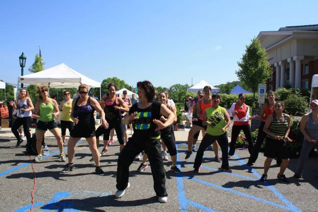 Sam Le Valley leading a Zumba group on opening day of the Sparta Farmer's Market
