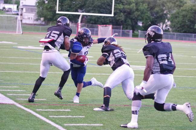 Sussex Stags receiver Robert Cousar is contronted by several defenders after catching the ball in the second quarter.