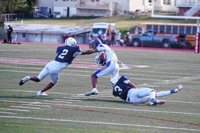 <b>Sussex defenders work in tandem to bring down a Monroe ball carrier.</b>