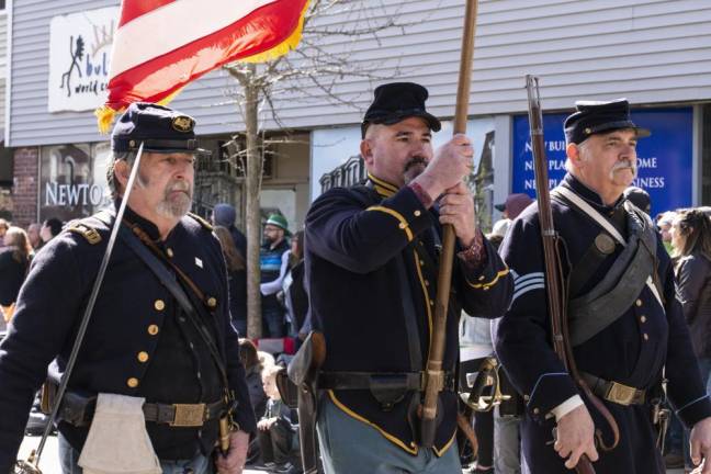 Civil War re-enactors march in the parade.