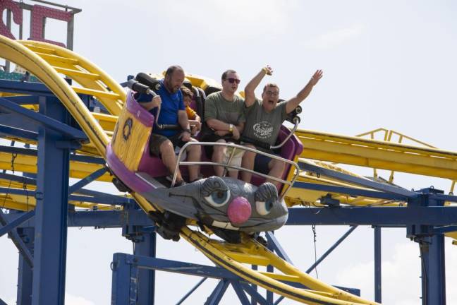 Fairgoers on a thrill ride. (Photo by John Hester)