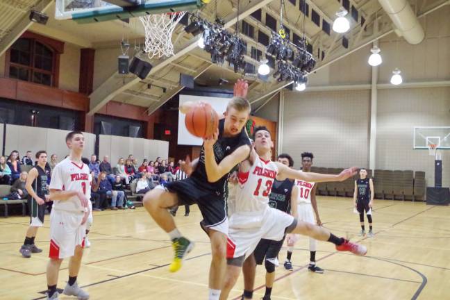 Veritas' Aaron Burke grabs the rebound. Burke scored 11 points, grabbed 16 rebounds, and had four steals.