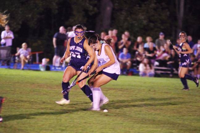 Pope John's Adriana Purcell battles Sparta's Lauren Groff for control of the ball.
