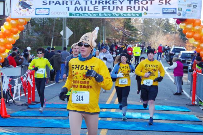 Forty six year old Anita Dematto (314) of Hackettstown, New Jersey crosses the 5K finish line. Dematto's time was 26:53.4 and she finished 427 out of 1954 runners.