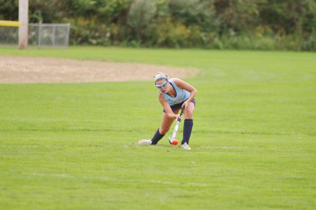 Sparta's Audrey Krajicek hits the ball with her stick in the first half.