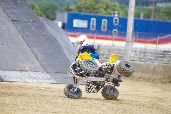 Stuntman Derek Guetter balances an all terrain vehicle on two wheels.