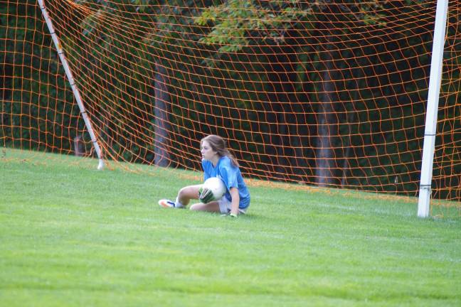 Sparta goal keeper Julia Flake rises off of the ground after an interception.