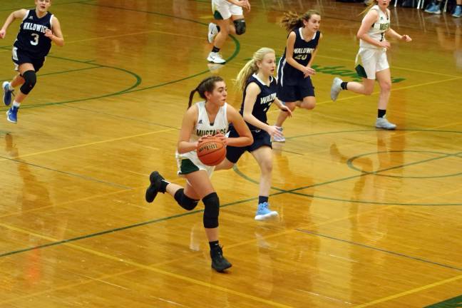 Sussex Tech's Brooke Munoz dribbles the ball during a fast break. Munoz scored six points and grabbed twelve rebounds.