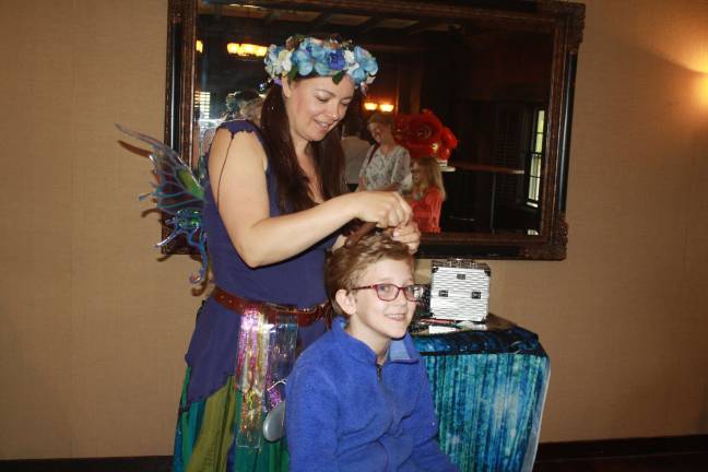 A little fairy hair never hurt anyone—Lillian Bankers, age 8, patiently sits as Kate Fresso of Luna Locks does her magic.