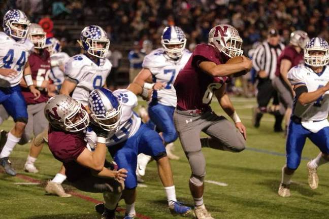 Newton ball carrier Nicholas Brigante moves forward in the first half. Brigante scored one touchdown.