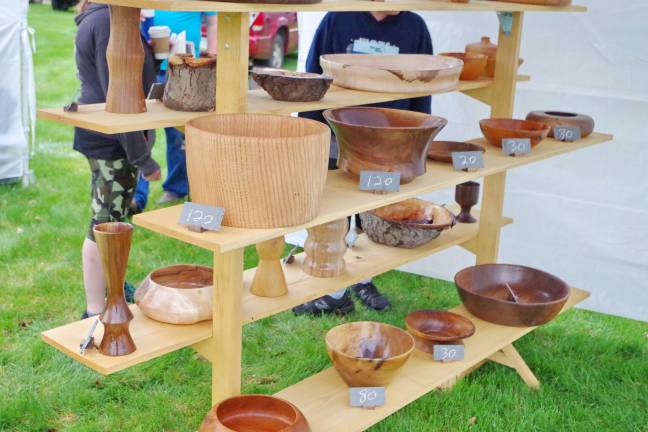Different types of bowls, vases and other items made of wood on display.